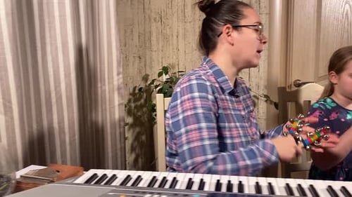 Woman and Girl Playing Music Together Indoors