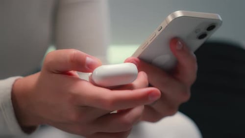 Close Up Unrecognizable Woman Holding Mobile Phone Gadget Connecting with Headphones Connect