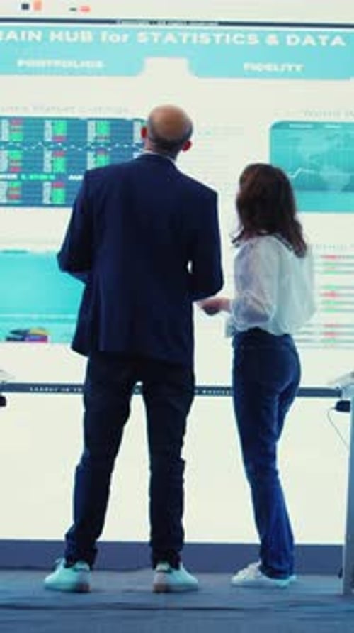 Business Professionals Analyzing Financial Data on Screen