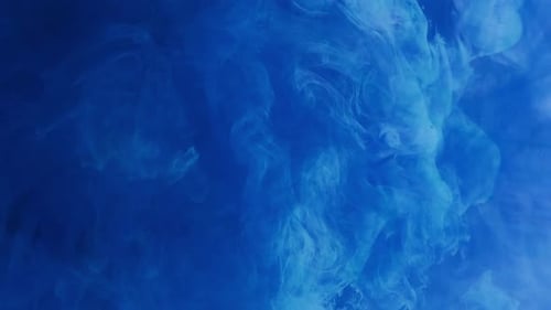 Abstract Plumes of Blue Ink Swirling in Liquid