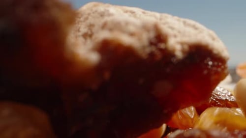 Dried fruits are falling on the table from the sky. Dolly slider extreme close-up. Laowa Probe