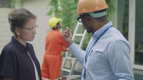 Engineer Discussing with Woman Solar Panels Installation