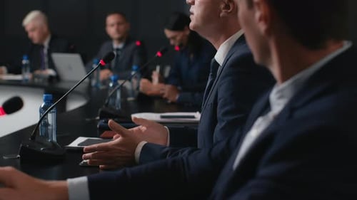 Speech Of Political Speaker At Meeting Room Of Business Center. Adult Man In Suit Explains Leader...