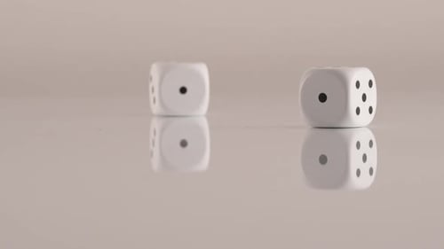Rolling White Dice on Reflective Surface