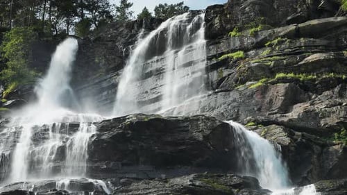 Picturesque Waterfall Flowing Over Rocky Cliffs