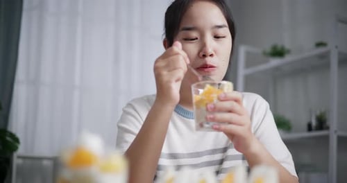 Girl Eating Fruit and Yogurt Parfait Dessert