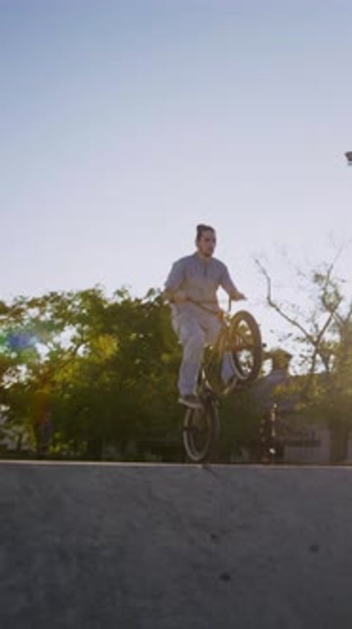 Man Jumping and Riding BMX Bike in Skate Park
