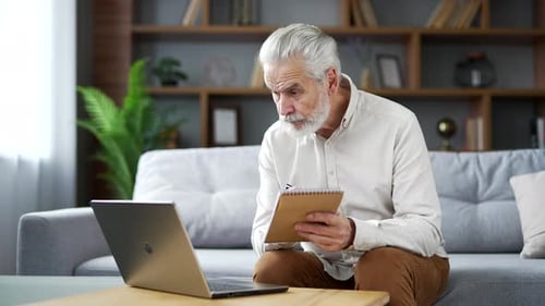 Senior Man Working on Laptop at Home
