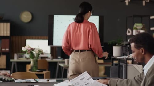 Biracial Colleagues Working in Modern Office