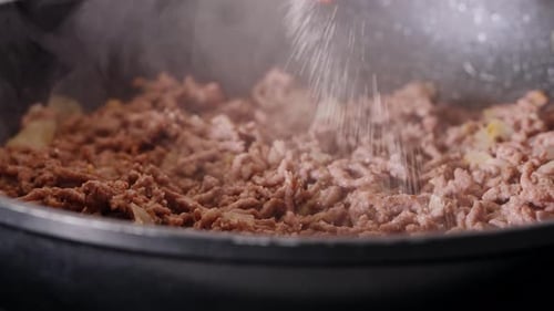 Ground Meat Cooking in Pan with Onions and Seasoning