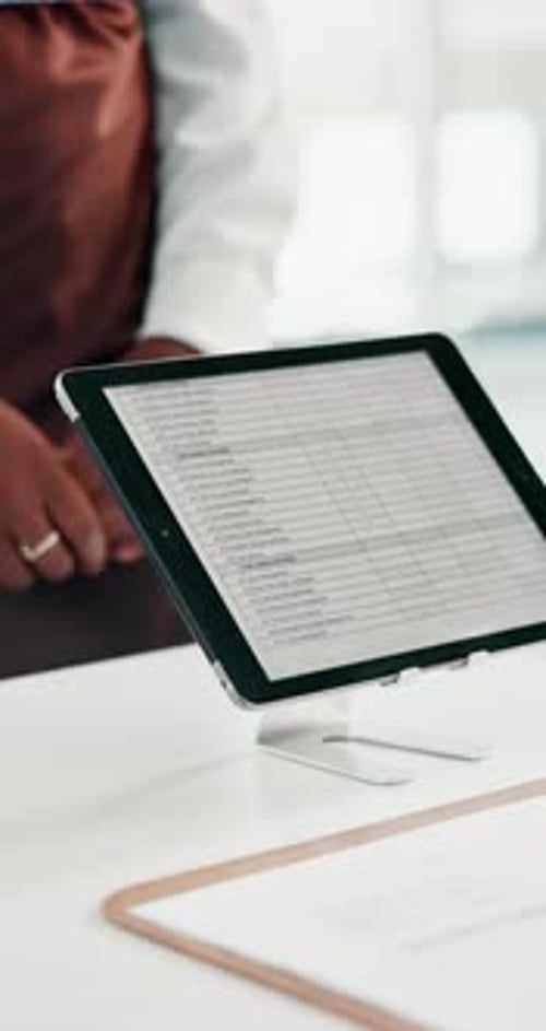 Tablet, screen and hands at front desk of office with guest arrival pass for conference