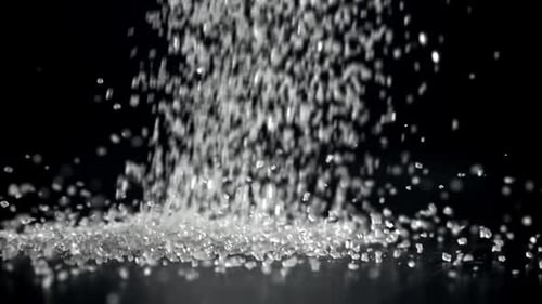 Sugar Falls on the Table in a Heap Filmed on a Highspeed Camera at 1000 Fps