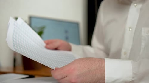 Close Up Man Manage Financial Documents at Home Office Read Sales Reports Unrecognizable Businessman