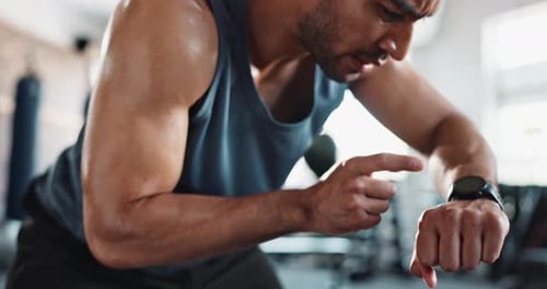 Man, breathing and smart watch in gym for fitness, exercise and break with challenge