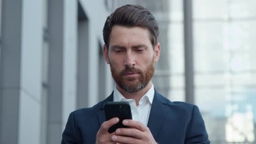 Adult Caucasian Businessman Holding Smartphone Mobile Phone in City Business Man Using Modern