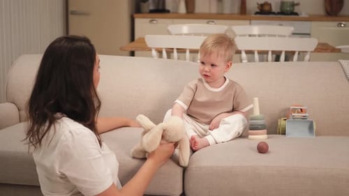 Mother and Child Playing on Sofa