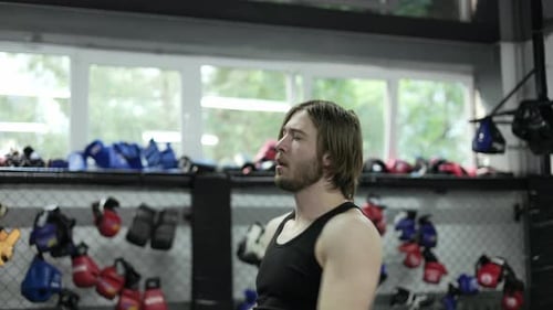 Man Exercising With Resistance Band in Gym