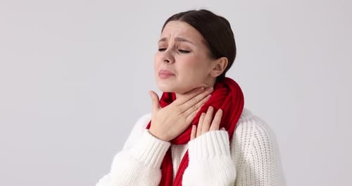 Woman with Sore Throat Holding Neck in Pain