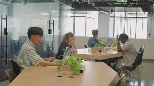 People Working at Desks in Modern Office