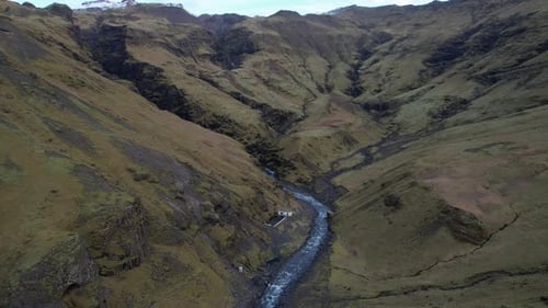Huge green mountains high in grass and moss with many small streams and waterfalls. in Iceland