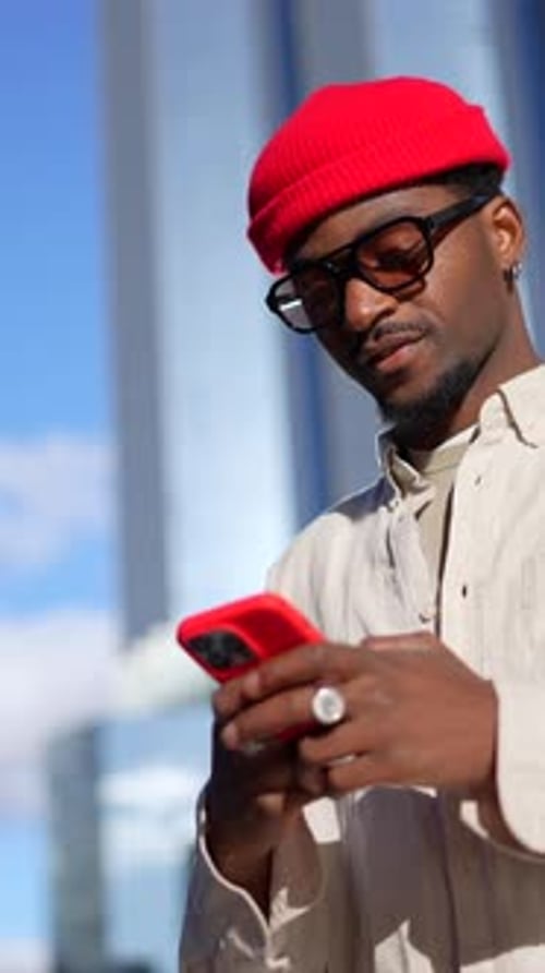 Stylish Man Using Phone in Urban Setting