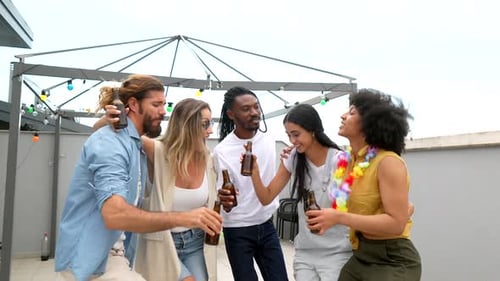 Friends Celebrate with Beer on Rooftop Patio