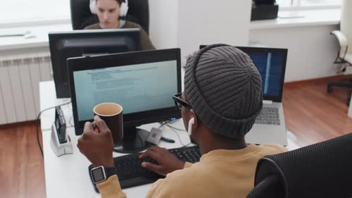 Young Man At Work In IT Company Office