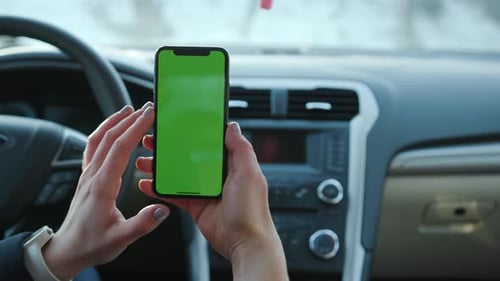 Paris France April 5 2018 Woman Hands Holding Use Phone with Vertical Green Screen in Car Transport