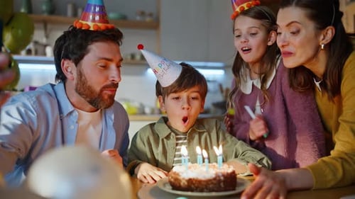Family Celebrating Birthday with Cake and Phone Call