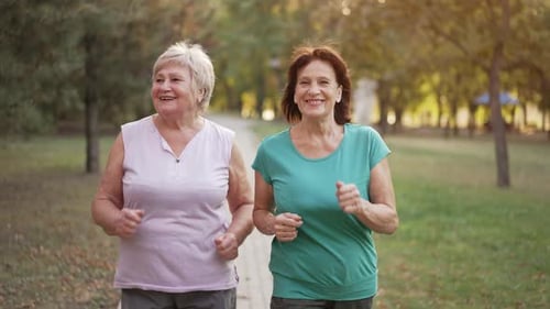 Two Old Cheerful Women Do Sports at the Park