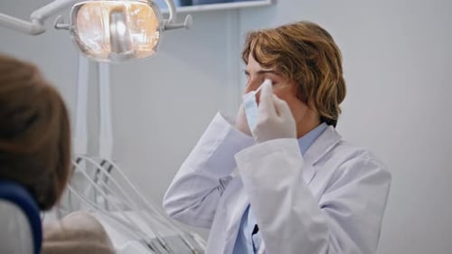 Stomatology Professional Preparing Treatment Taking on Protective Mask Closeup
