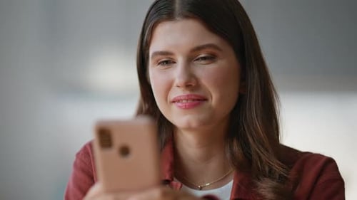 Smiling Woman Looking at Cellphone Close Up