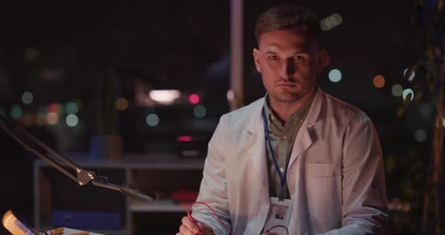 Scientist at Desk Works Late at Night