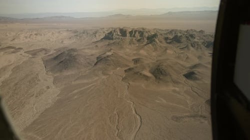 Experience breathtaking views of the desert terrain from a helicopter, capturing the intricate detai