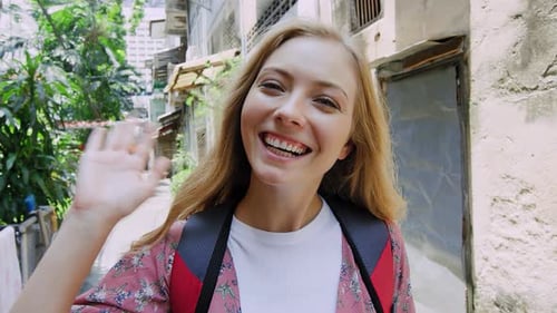 Portrait of Beautiful Backpacker Tourist Girl Waving at Camera on Bangkok Asian