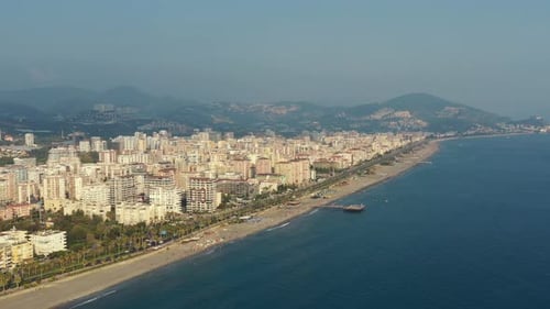 Aerial panoramic view of modern city with beach and traffic at daytime