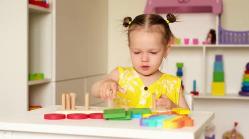 Young Child Plays with Educational Wooden Shape Toy