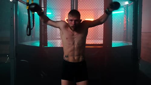 Boxer Training in Boxing Ring with Boxing Gloves