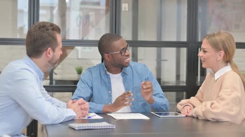 Mixed Race Entrepreneurs Discussing Work in Office