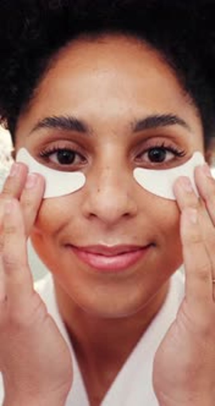 Beauty, eye mask and face of woman in bathroom of home for cosmetic or ...