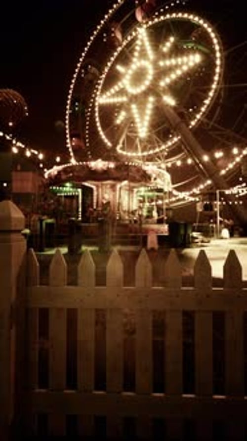 Illuminated Merry Go Round in Abandoned Amusement Park