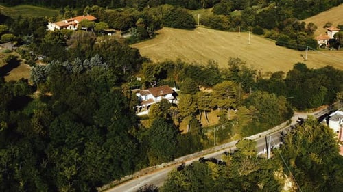 Drone Zooming Out Above Houses on Green Hills to Reveal Amazing Summer Sandy Sea Beach on Sunny Day