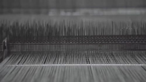 Weaving machine with lots of white threads getting run through it