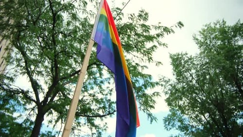 Pride Flag Waving in the City Wind