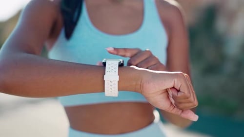 Young Adult Uses Smart Watch During Outdoor Workout