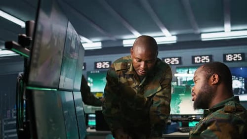 Team of Soldiers Looking at Screens in Command Center