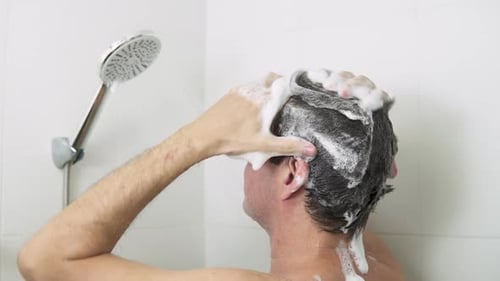 Man Washing Hair with Shampoo in Shower