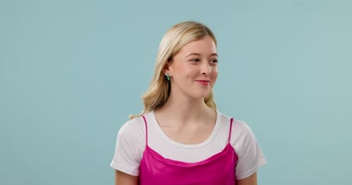 Woman, secret and hand on lips in studio for gossip, surprise or announcement on blue background