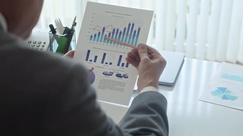 Financial Manager Analyzing Business Chart at Office