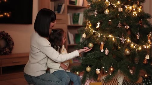 Woman and Child Decorating Christmas Tree Together